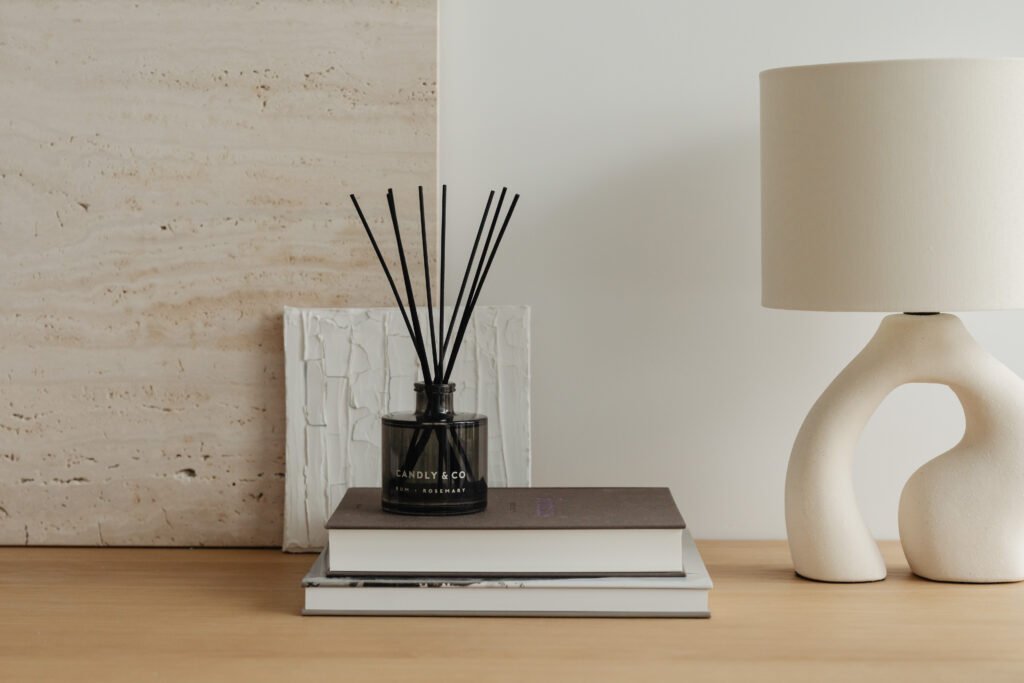Difusor de aroma y vela sobre libros. Escena que evoca bienestar y equilibrio sensorial.